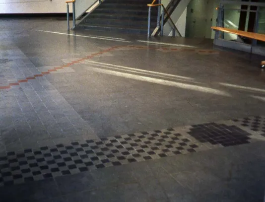 Grey greenstone and slate floor with red accents and a checkers-like pattern.