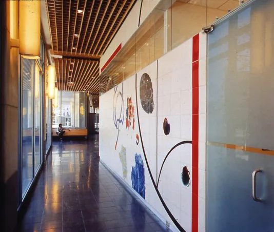 225-foot-long ceramic mural installed along a hallway with one long wall of windows